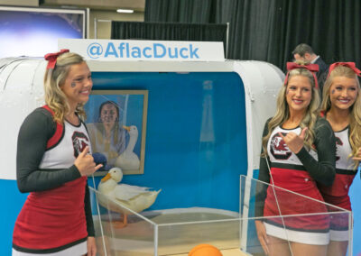 Aflac duck photo op with cheerleaders